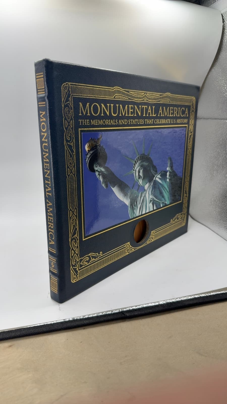 Monumental America: The Memorials and Statues That Celebrate U.S. History. Missing Coin by Lisa Brooks - quarter view showing binding condition