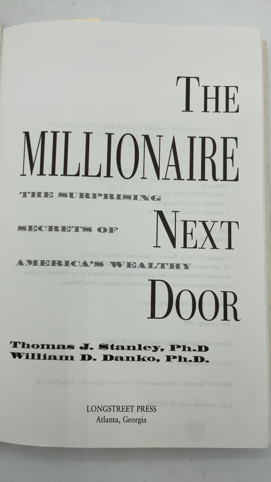 The Millionaire Next Door: The Surprising Secrets of America's Wealthy by Thomas J. Stanley, Ph.D. and William D. Danko, Ph.D. - title page