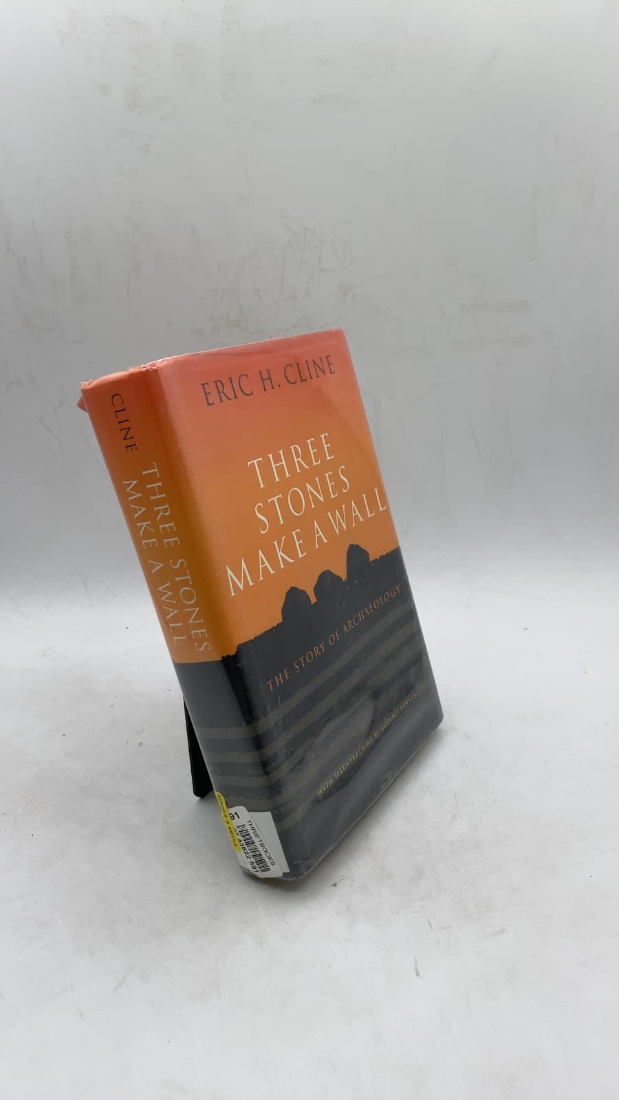 Three Stones Make a Wall: The Story of Archaeology by Eric H. Cline - front cover