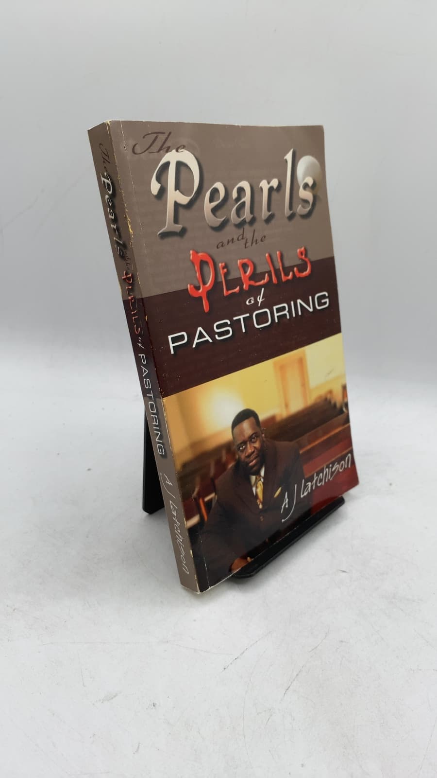 The Pearls and the Perils of Pastoring by Andrew J. Latchison, Jr. - front cover