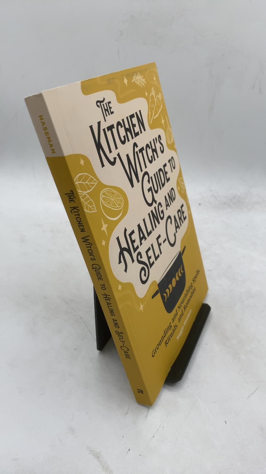The Kitchen Witch's Guide to Healing and Self-Care: Grounding and Nourishing Spells, Rituals, and Remedies by Maggie Haseman - front cover