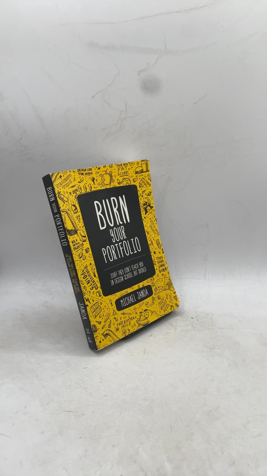 Burn Your Portfolio: Stuff They Don't Teach You in Design School, But Should by Michael Janda - front cover
